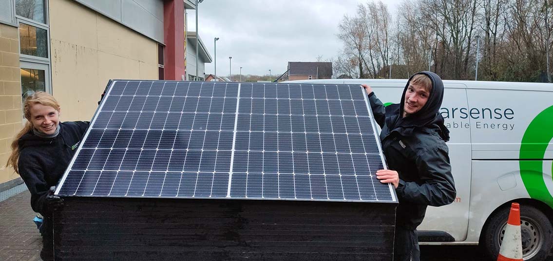 SolarSense team with new panels at office
