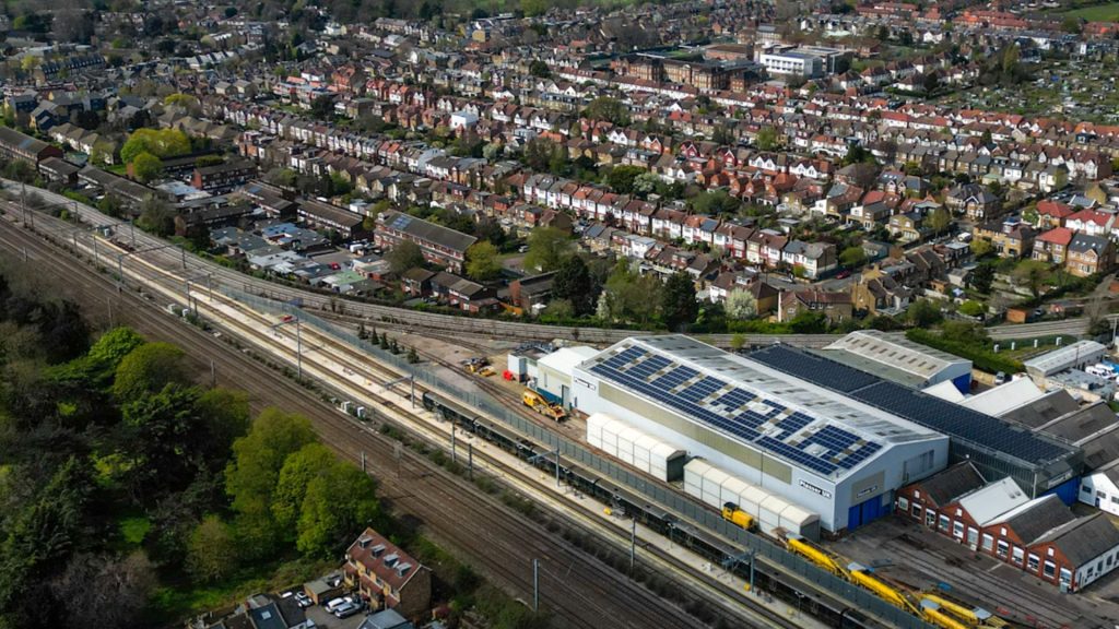 drone shot of commercial solar panels on industrial building